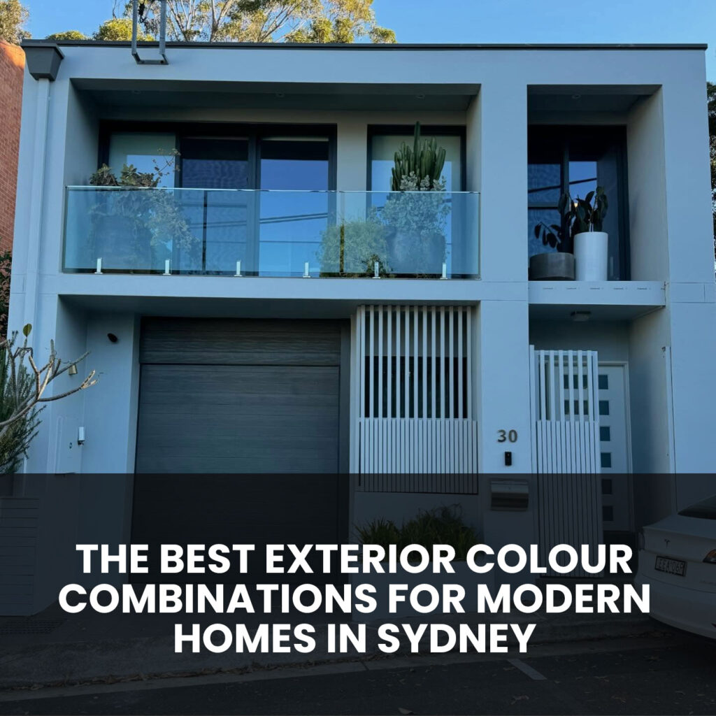 Modern Sydney home exterior with grey façade, charcoal garage door and glass balcony
