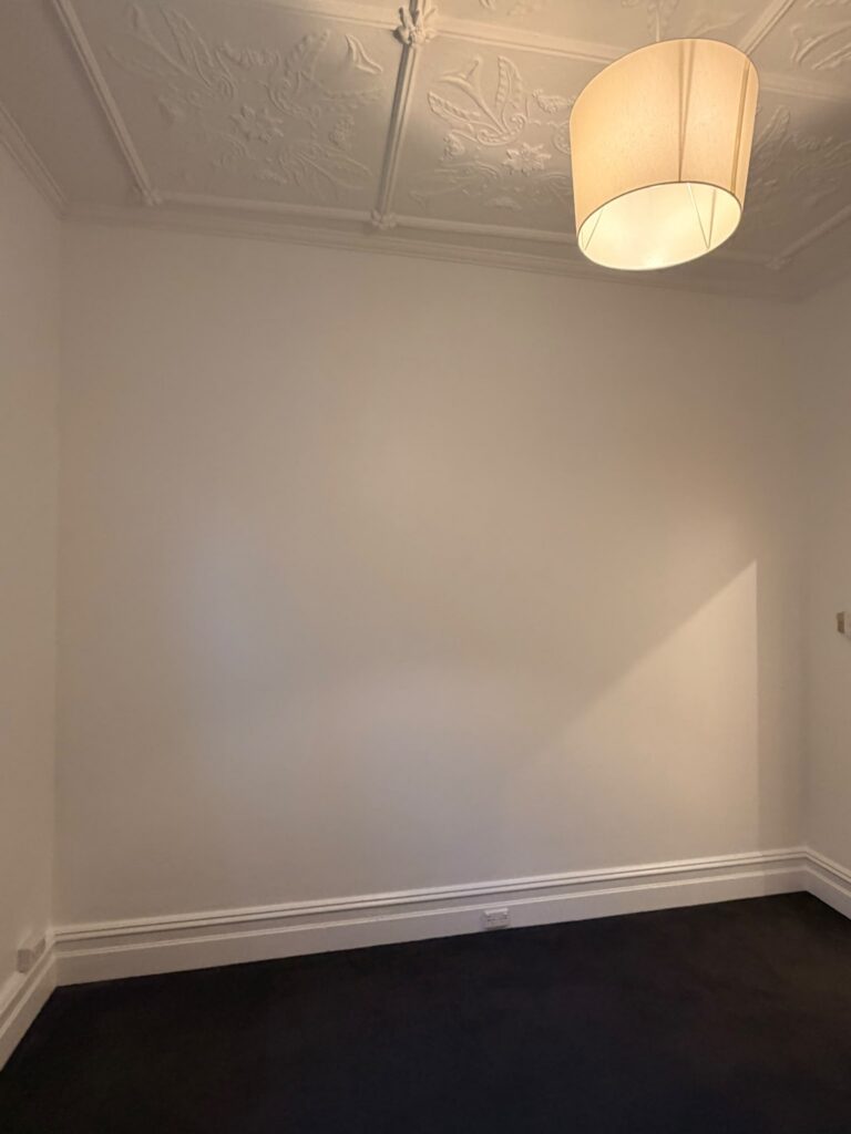 Freshly repainted interior wall and restored ceiling by AKD Painting, Inner West Sydney, after