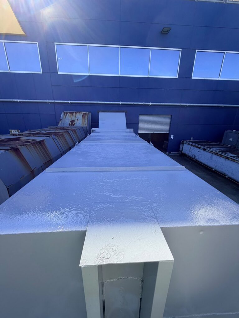 Coated compactor beside rusted units showing before and after at IKEA Rhodes