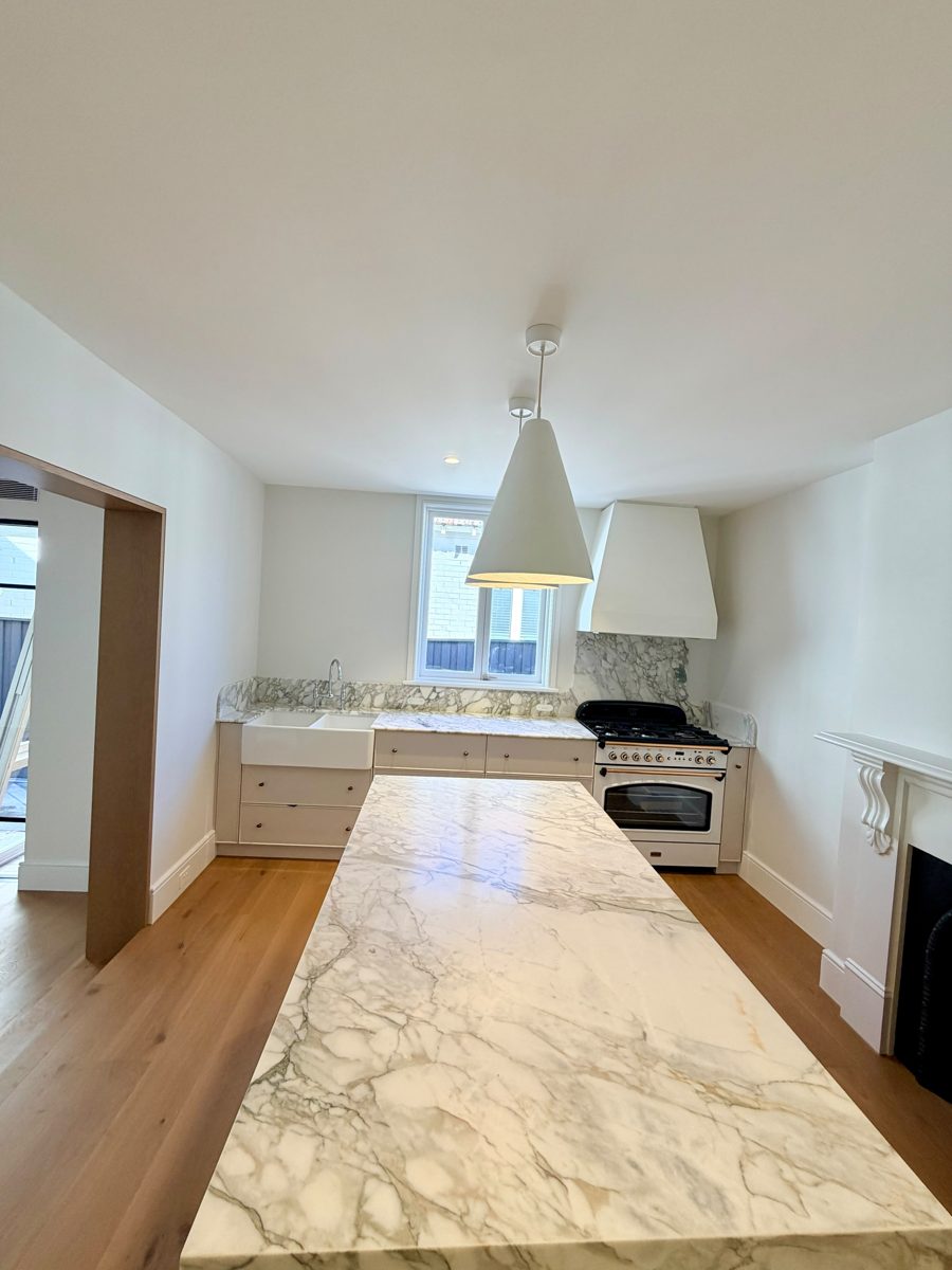 Wide view of the new kitchen in an Annandale extension with painted ceiling, walls and cabinetry