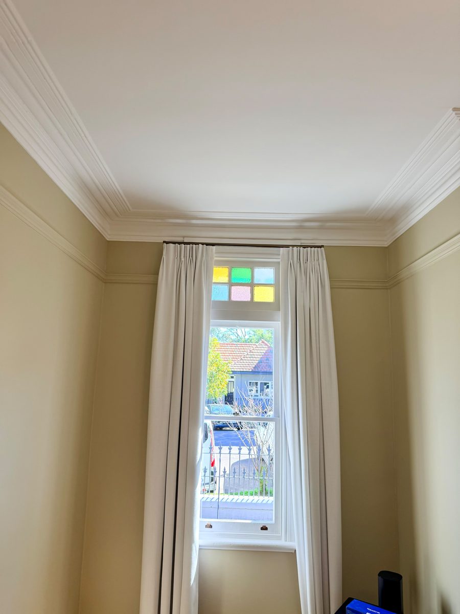 Period front room in Annandale with leadlight sash window, repainted walls in warm neutral and white cornice