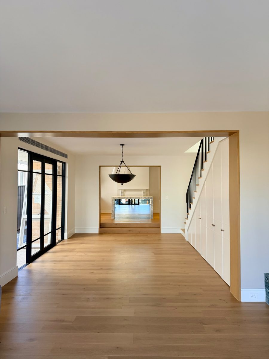 Open-plan rear extension in Annandale looking back to the kitchen and stair, walls painted in off-white