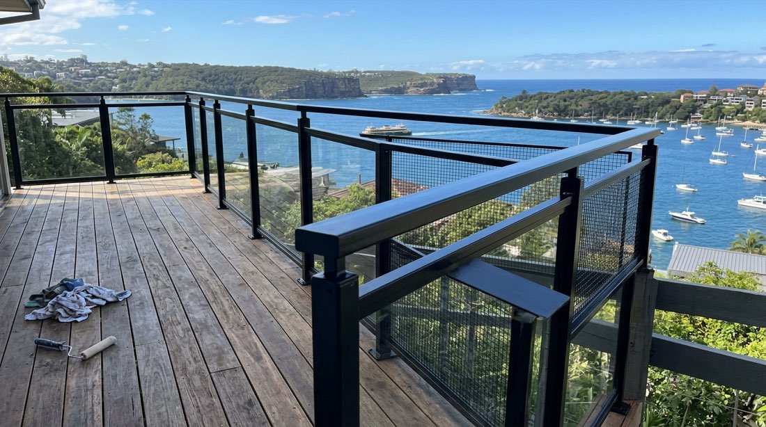 Coastal deck with a freshly painted steel balustrade looking out over the water