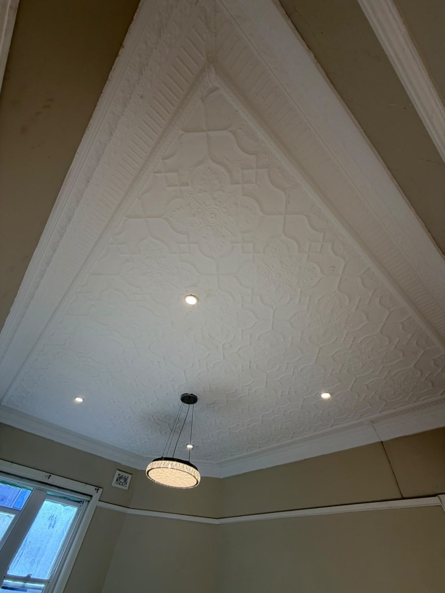 Pressed metal ceiling after restoration in the Inner West, border and cornice repainted