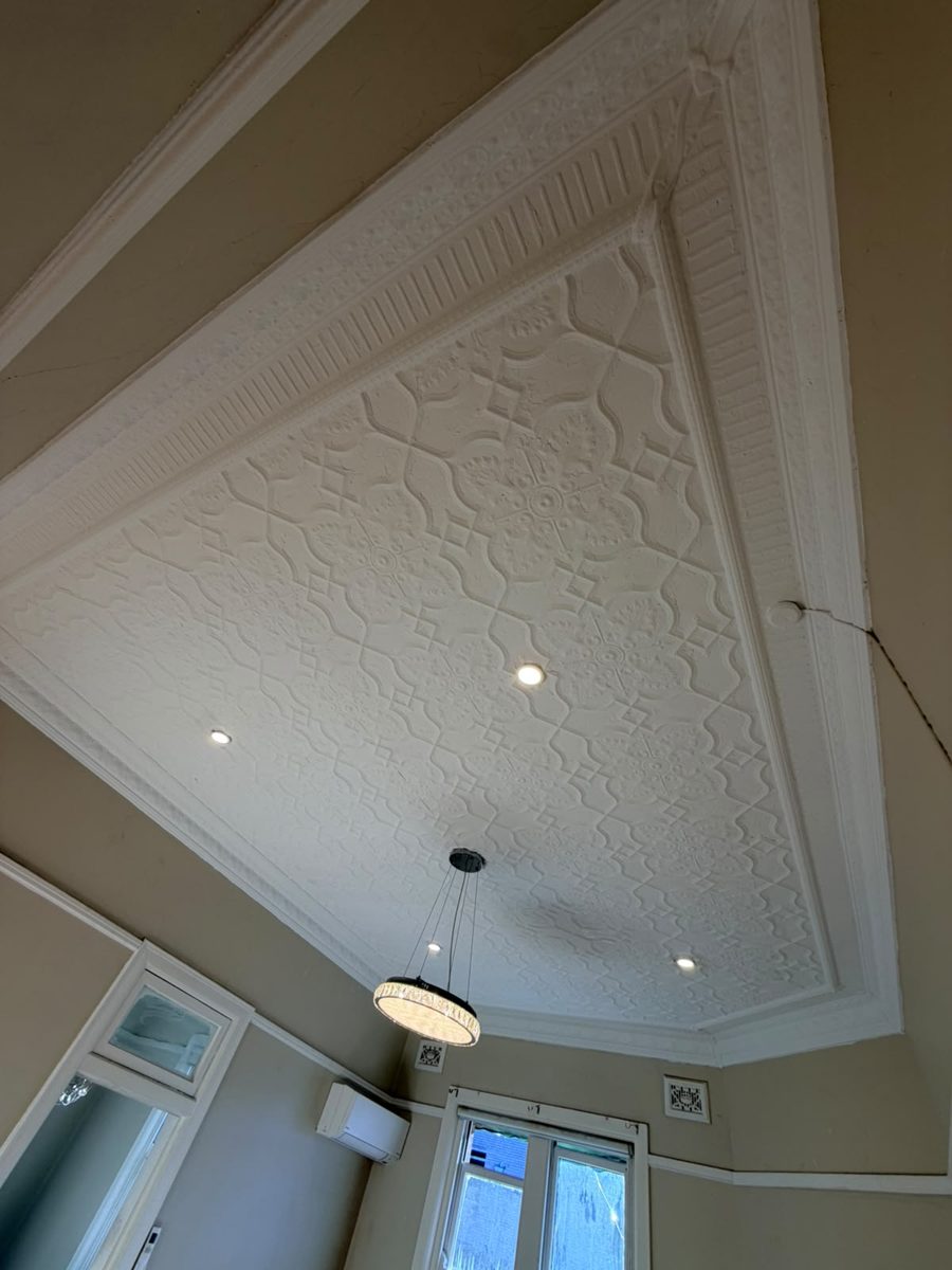 Restored and repainted pressed metal ceiling with cornice in an Inner West period home