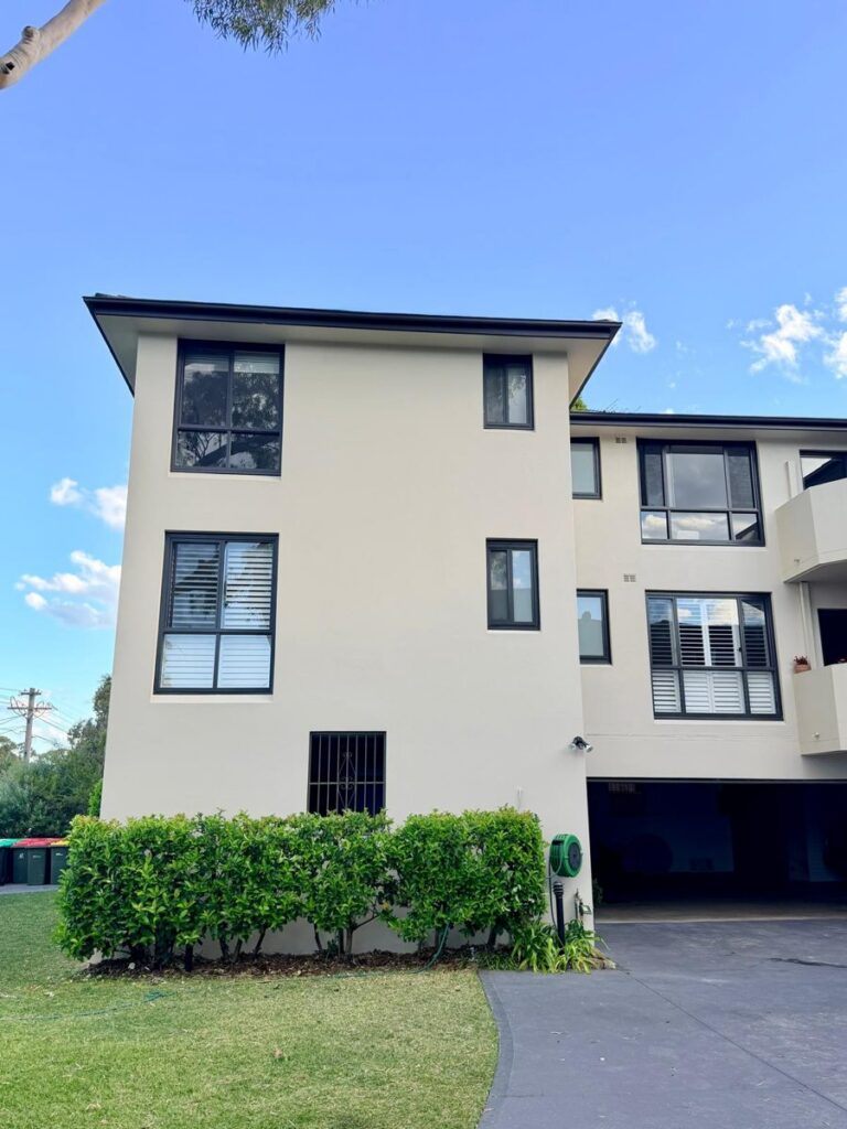 Canada Bay strata walk-up after exterior repaint, warm off-white render with charcoal window frames