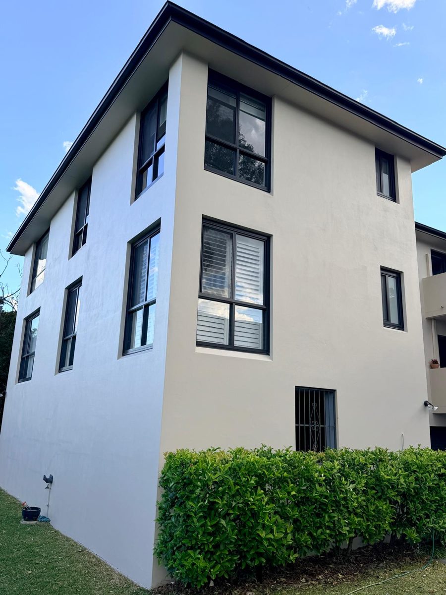 Rear of a Canada Bay strata block after repainting with charcoal garage doors