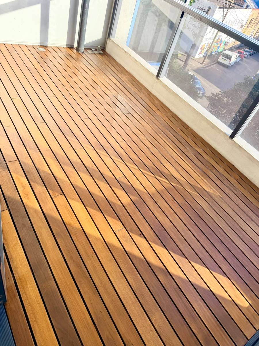 Timber balcony deck restored and freshly oiled to a warm finish in the Inner West