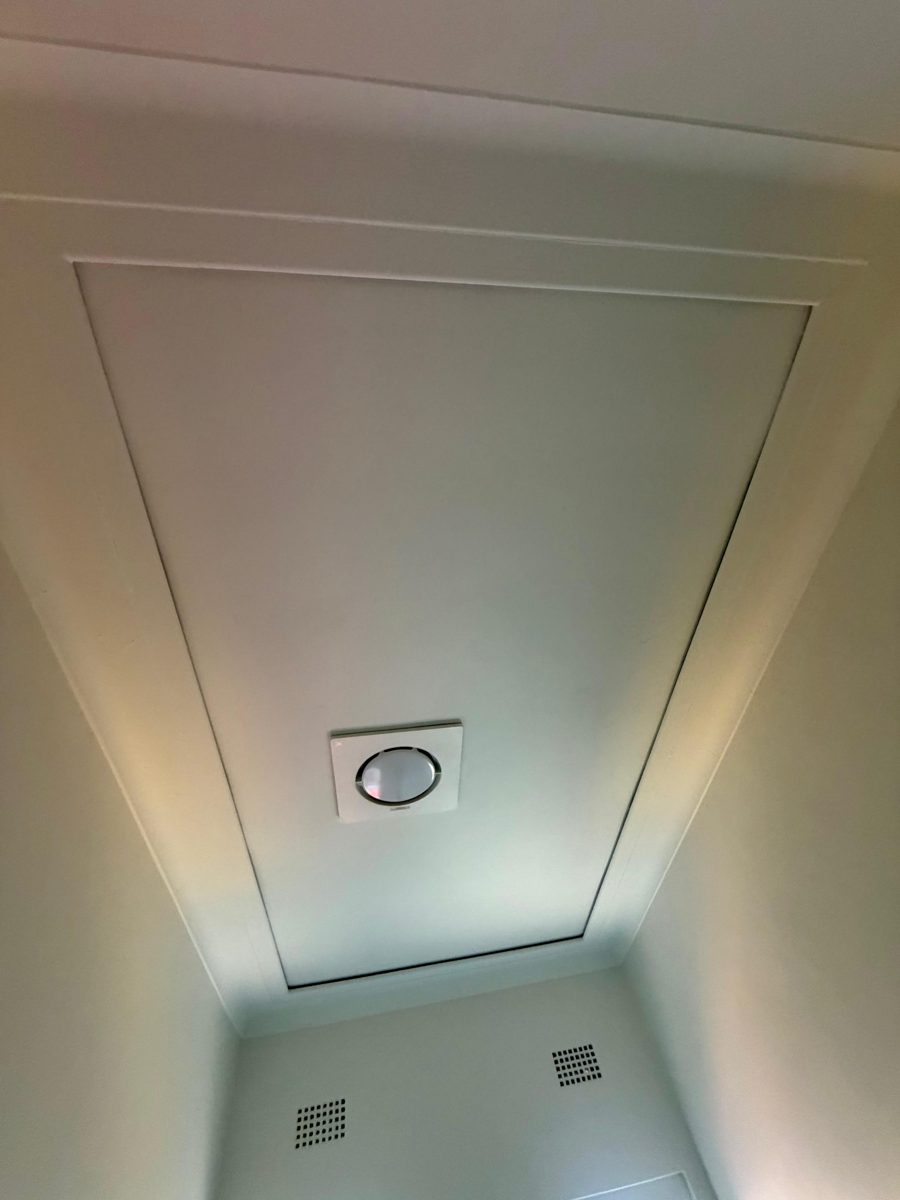 The same Inner West ceiling repainted white with the new fitting in place and the cornice frame cut in
