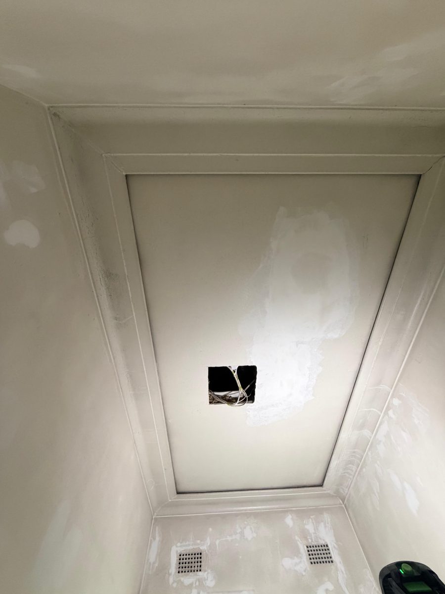 Plaster ceiling in an Inner West home patched around a cut-out left by electrical work, before repainting