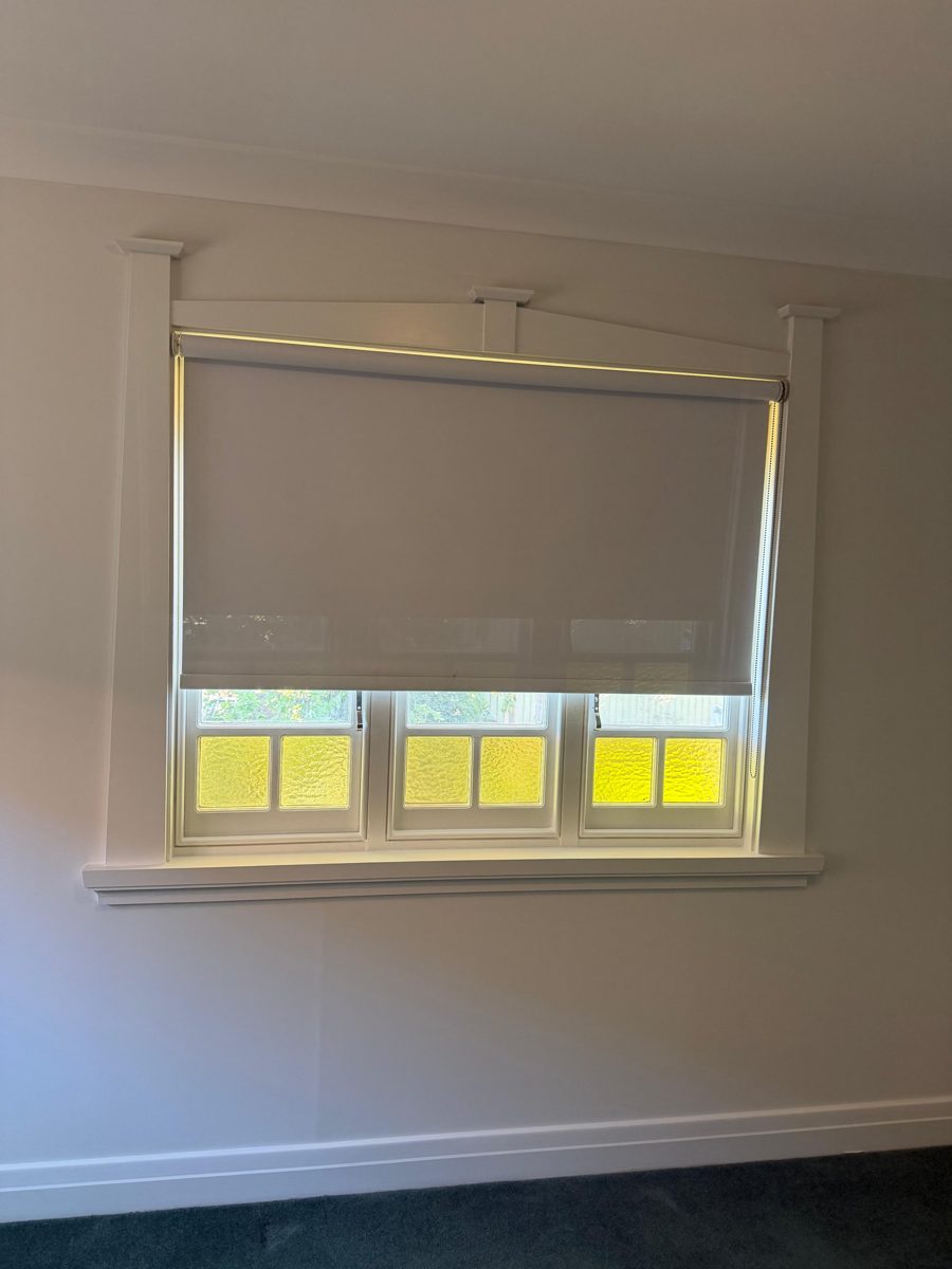 Finished bedroom in a Five Dock Federation home with a leadlight window and white walls