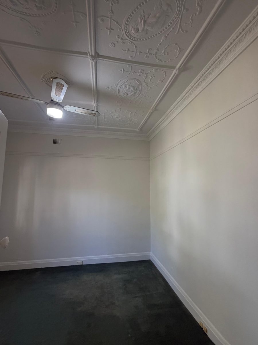 Finished bedroom in a Five Dock Federation home with white walls and a pressed metal ceiling