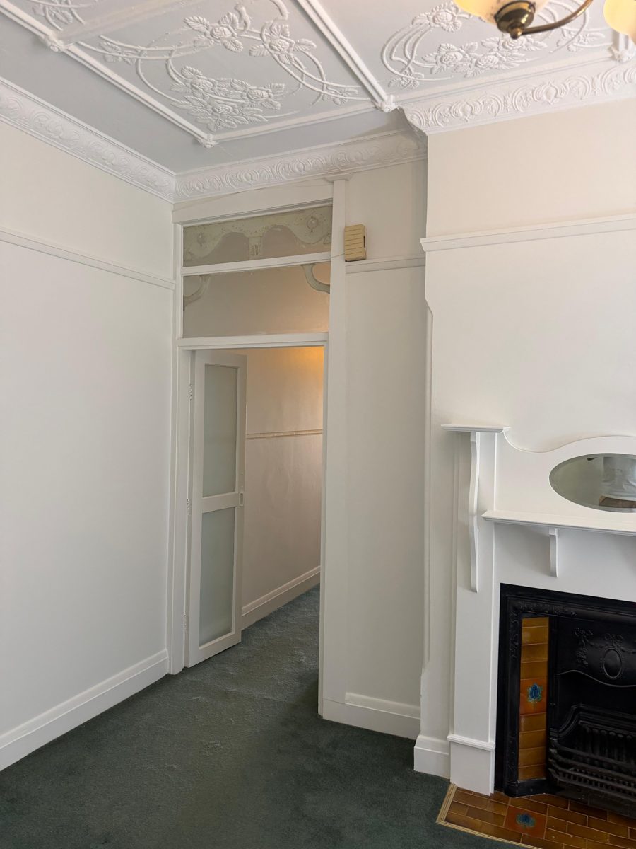 Finished fireplace mantel and doorway with leadlight fanlight in a Five Dock Federation home