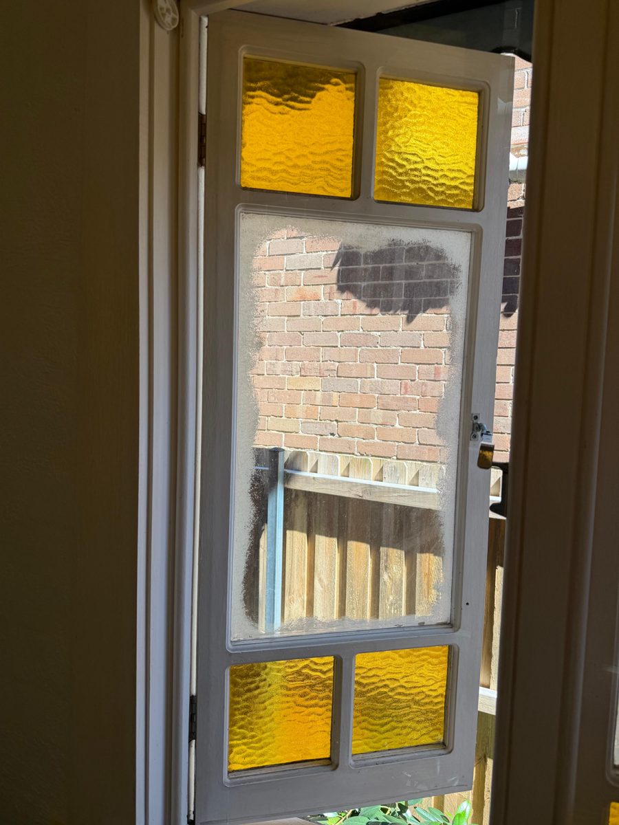 Leadlight casement window sash with amber glass being repainted in a Five Dock Federation home