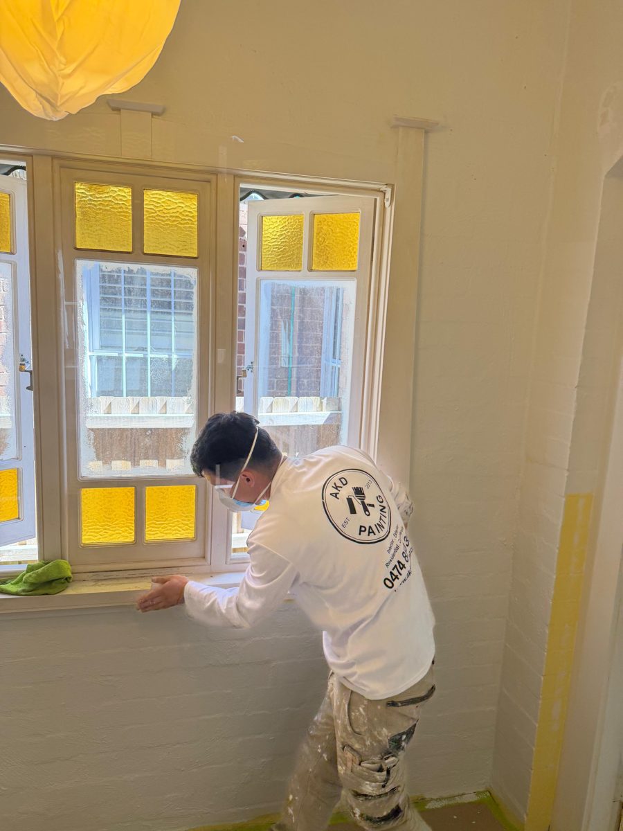 AKD painter preparing a leadlight window sill in a Five Dock Federation home